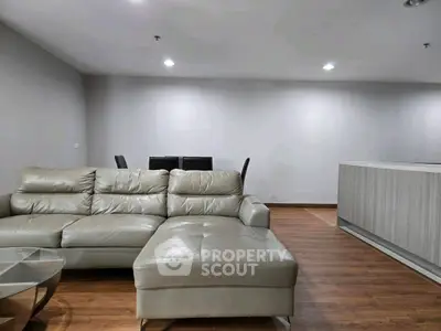 Modern living room with sleek leather sofa and glass coffee table