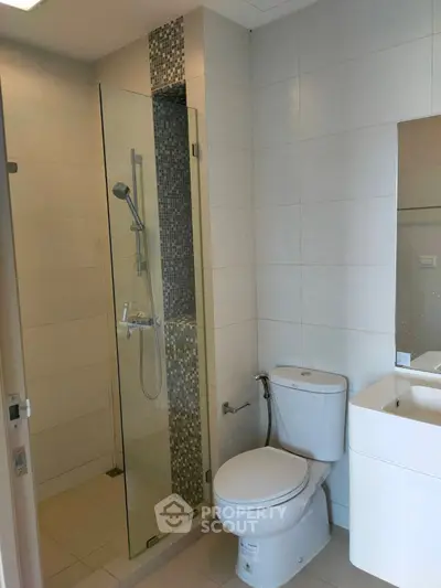 Modern bathroom with glass shower and sleek fixtures