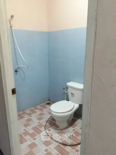 Simple bathroom with blue tiles and basic fixtures