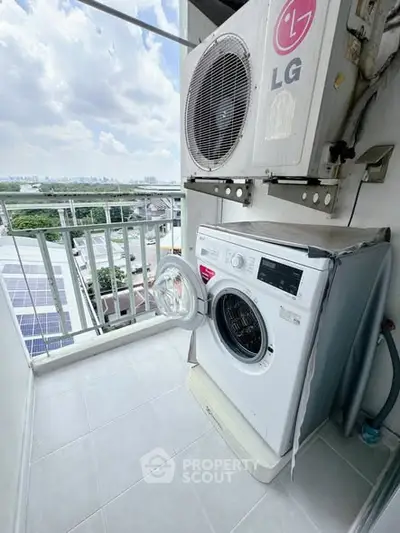 Compact balcony with washing machine and air conditioning unit, offering a practical outdoor utility space.