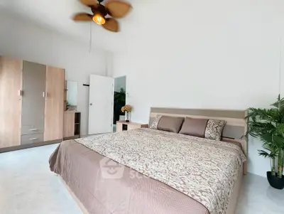 Spacious bedroom with modern decor and ceiling fan