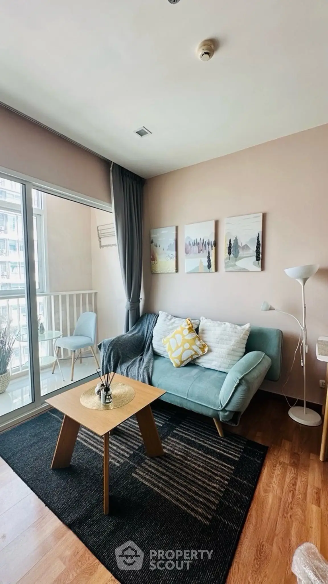 Chic living room with cozy sofa, stylish decor, and balcony view