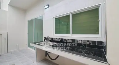 Modern outdoor kitchen with sleek black marble countertop and stainless steel sink