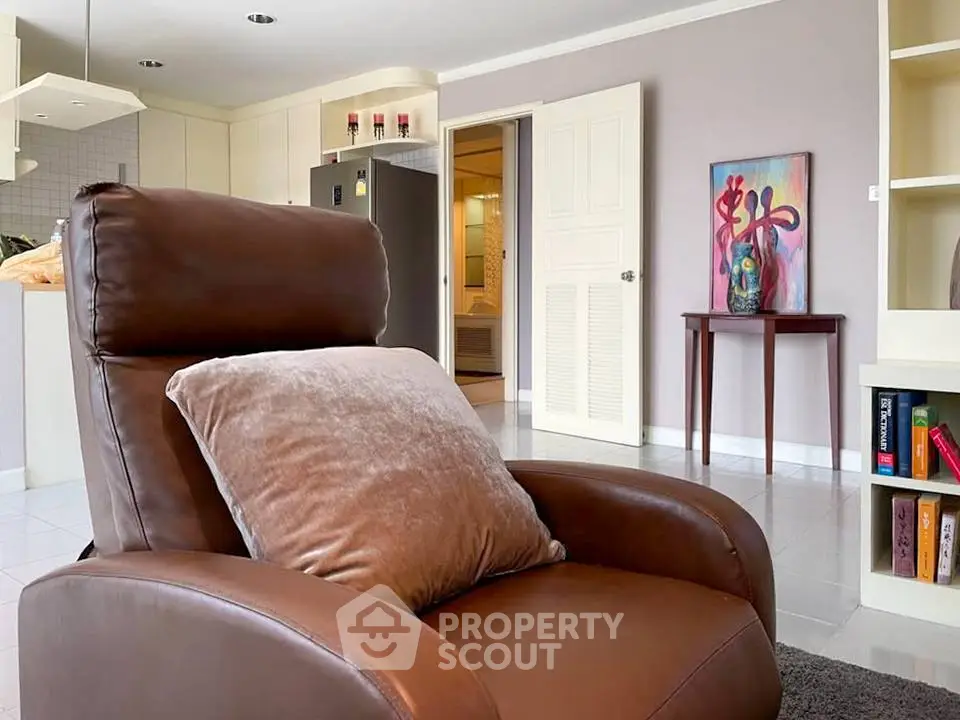 Spacious living room with cozy leather chair and modern decor