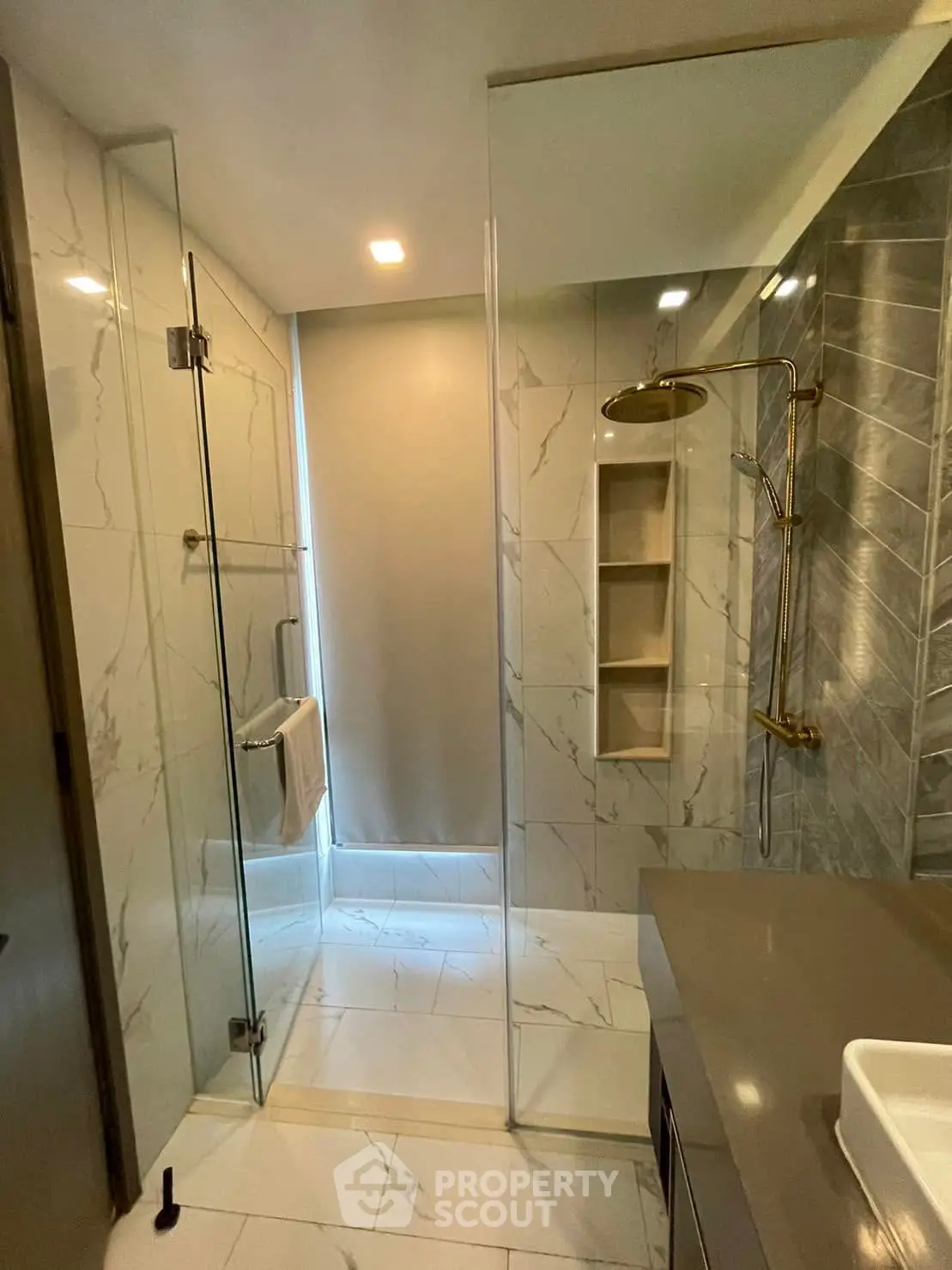 Luxurious modern bathroom with glass shower and elegant marble tiles