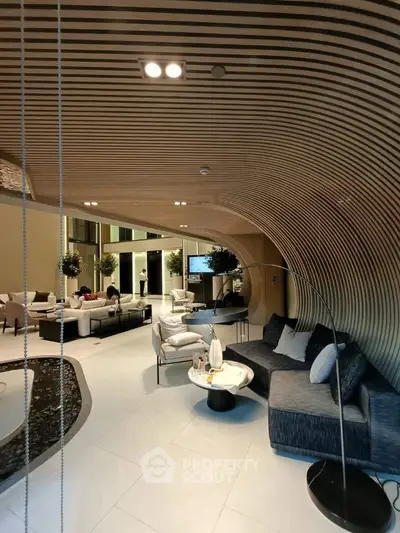 Luxurious modern living room with unique curved wooden ceiling and elegant furnishings.