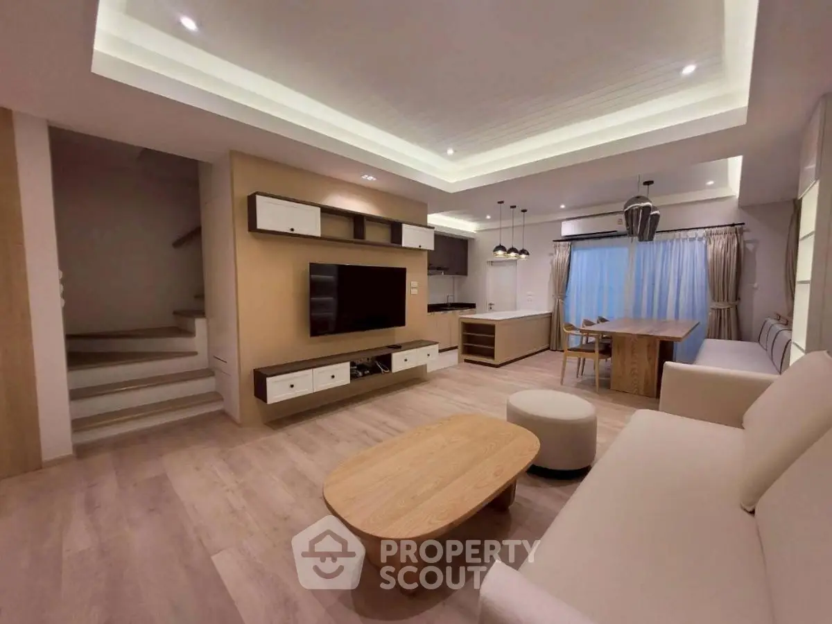 Spacious modern living room with open kitchen and stylish wooden furniture
