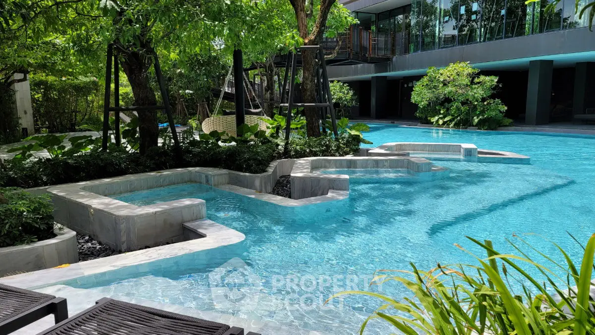 Luxurious pool area with lush greenery and modern design, perfect for relaxation and leisure.