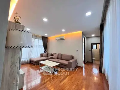 Spacious modern living room with wooden floors and stylish lighting