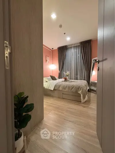 Cozy bedroom with modern decor and warm lighting, featuring a comfortable bed and stylish curtains.