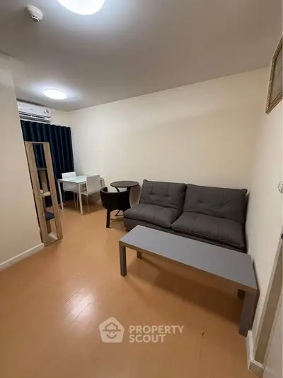 Cozy living room with modern furniture and wooden flooring in a stylish apartment.