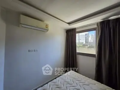 Cozy bedroom with air conditioning and natural light from window