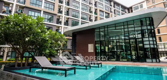 Modern apartment complex with stylish pool and lush greenery
