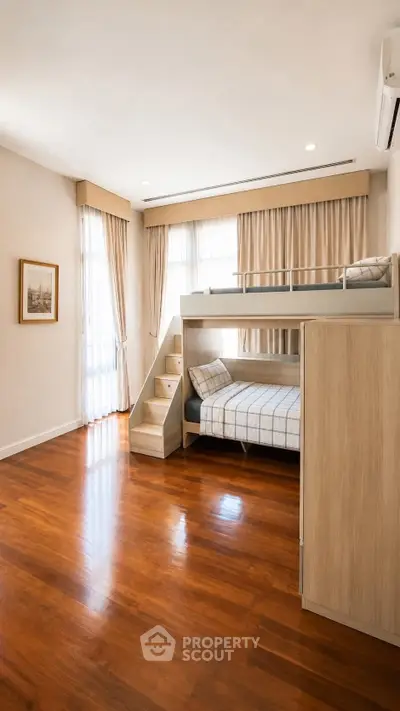 Spacious bedroom with bunk bed and wooden flooring, featuring large windows with curtains for natural light.