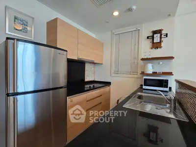 Modern kitchen with sleek appliances and wooden cabinetry