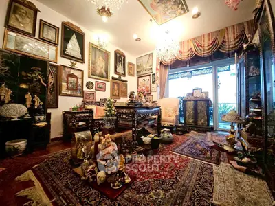 Luxurious living room with ornate decor and vintage charm, featuring elegant furniture and exquisite artwork.