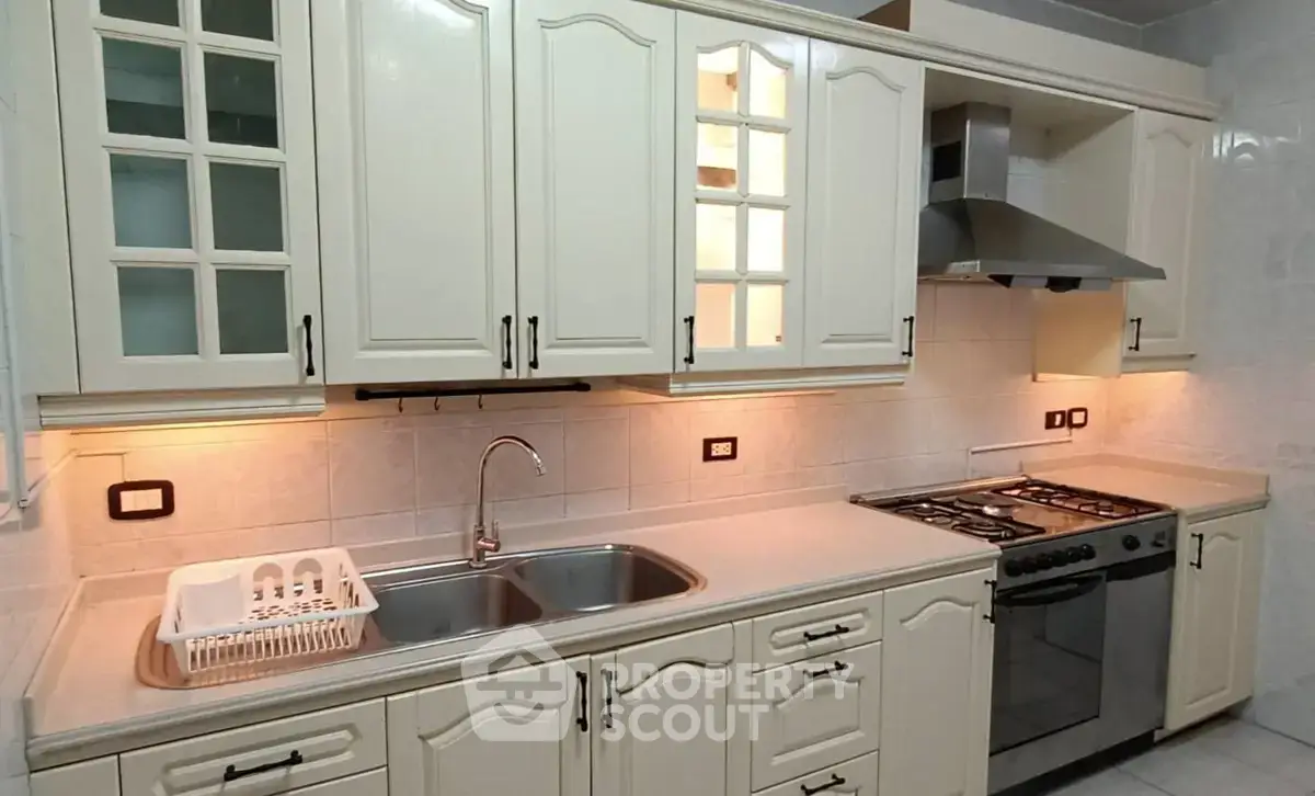 Spacious kitchen with modern appliances and elegant cabinetry, perfect for culinary enthusiasts.