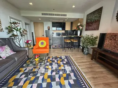 Stylish living room with modern decor and open kitchen layout