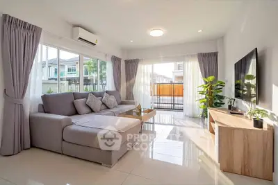 Spacious modern living room with large windows and stylish decor