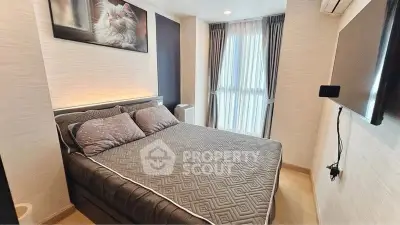 Modern bedroom with cozy bed, stylish decor, and natural light from large window.