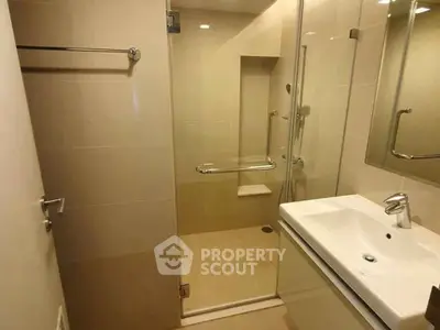 Modern bathroom with glass shower and sleek sink design