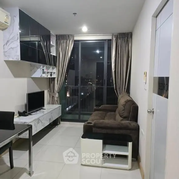 Modern living room with sleek furniture and city view balcony