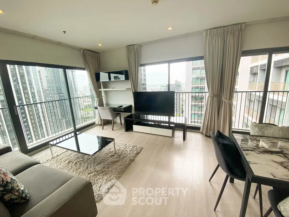 Spacious modern living room with large windows and city view