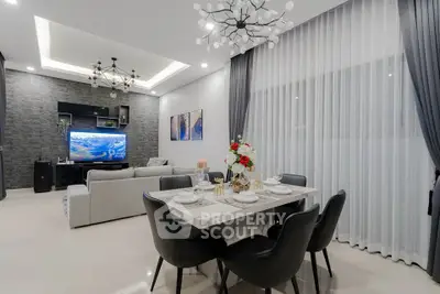 Luxurious modern living room with elegant dining area and stylish lighting fixtures.
