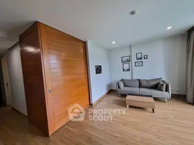Spacious living room with modern decor and wooden flooring