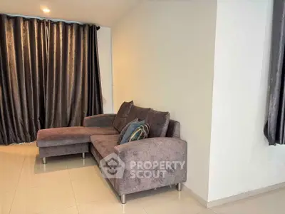 Modern living room with stylish gray sectional sofa and elegant curtains