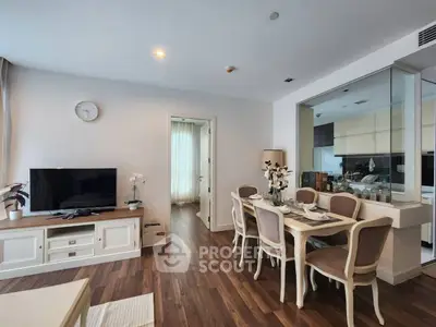 Elegant living room with dining area and modern kitchen in open layout.