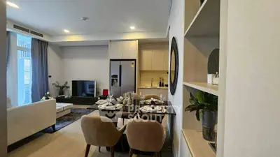 Modern open-plan living room and kitchen with elegant dining area and stylish decor.