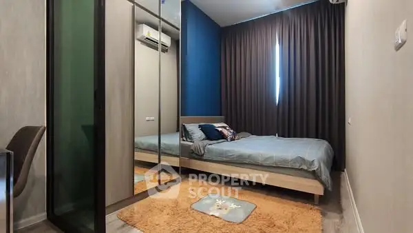 Cozy bedroom with mirrored wardrobe and modern decor