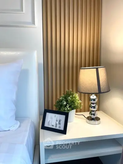 Stylish bedroom nightstand with modern lamp and decor