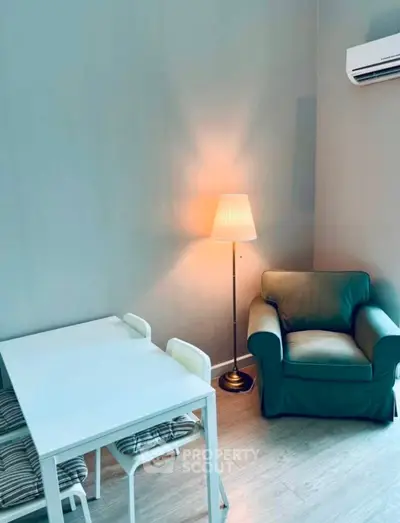Cozy corner with armchair, table, and lamp in modern apartment