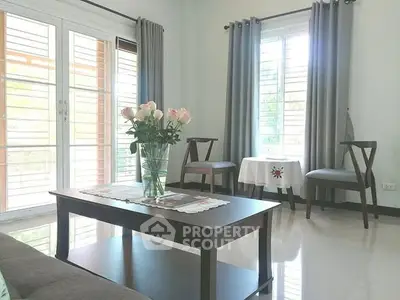 Bright and airy living room with elegant decor and large windows.