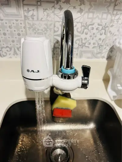 Modern kitchen sink with stylish faucet and backsplash design