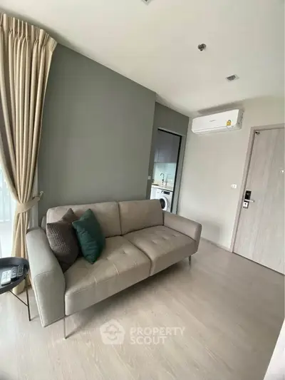 Modern living room with sleek sofa and air conditioning in stylish apartment.