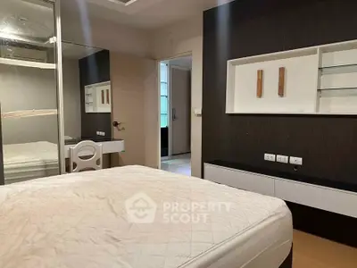 Modern bedroom with sleek design and built-in storage solutions.