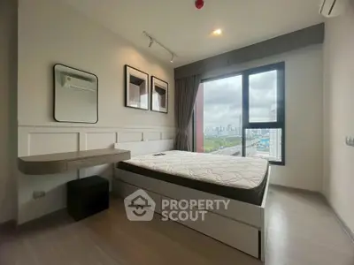 Modern bedroom with city view, featuring sleek design and natural light.