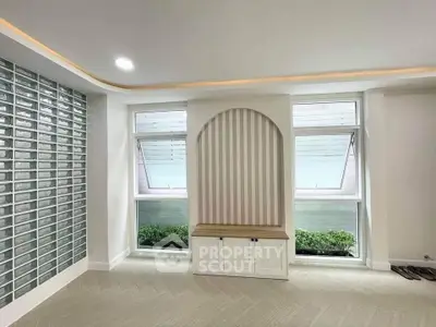 Modern living room with stylish windows and built-in storage bench