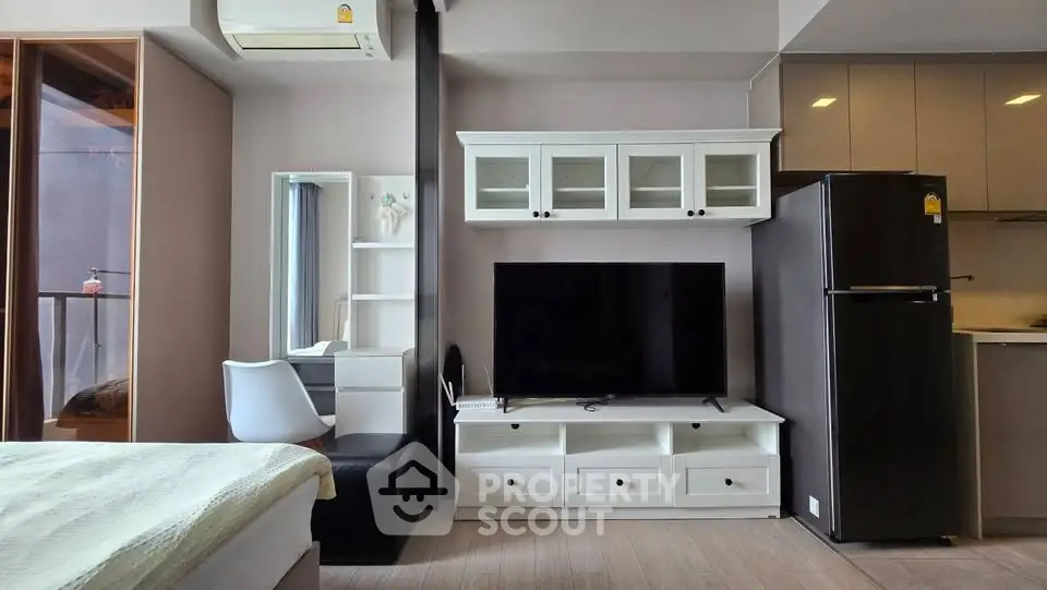 Modern living room with sleek furniture and large TV in stylish apartment