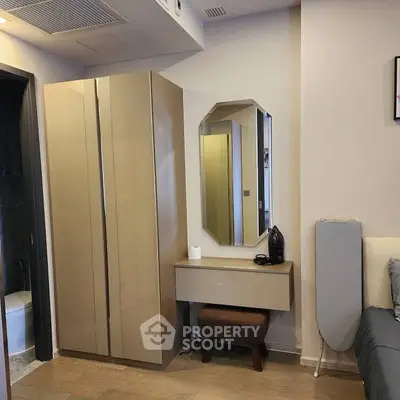 Modern bedroom corner with sleek wardrobe and stylish mirror