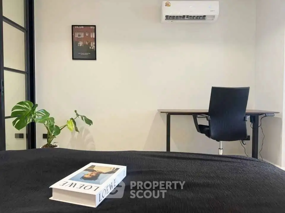 Modern study room with sleek desk, ergonomic chair, and air conditioning, perfect for productivity.