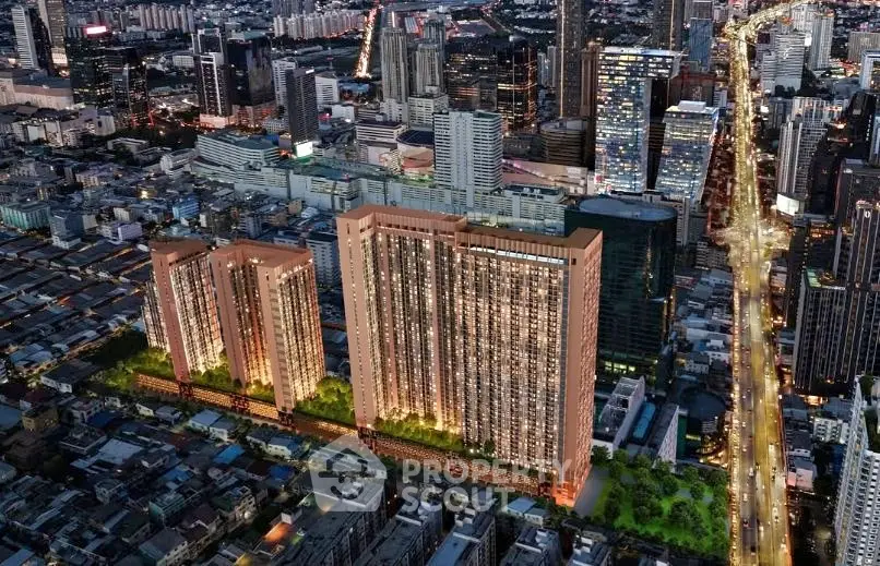 Stunning aerial view of modern high-rise buildings in bustling cityscape at night.
