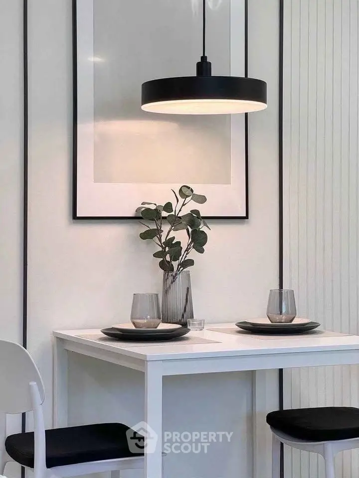 Stylish dining nook with modern decor and elegant lighting in a cozy apartment setting.