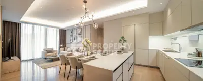 Luxurious open-plan living room and kitchen with modern decor and elegant lighting.