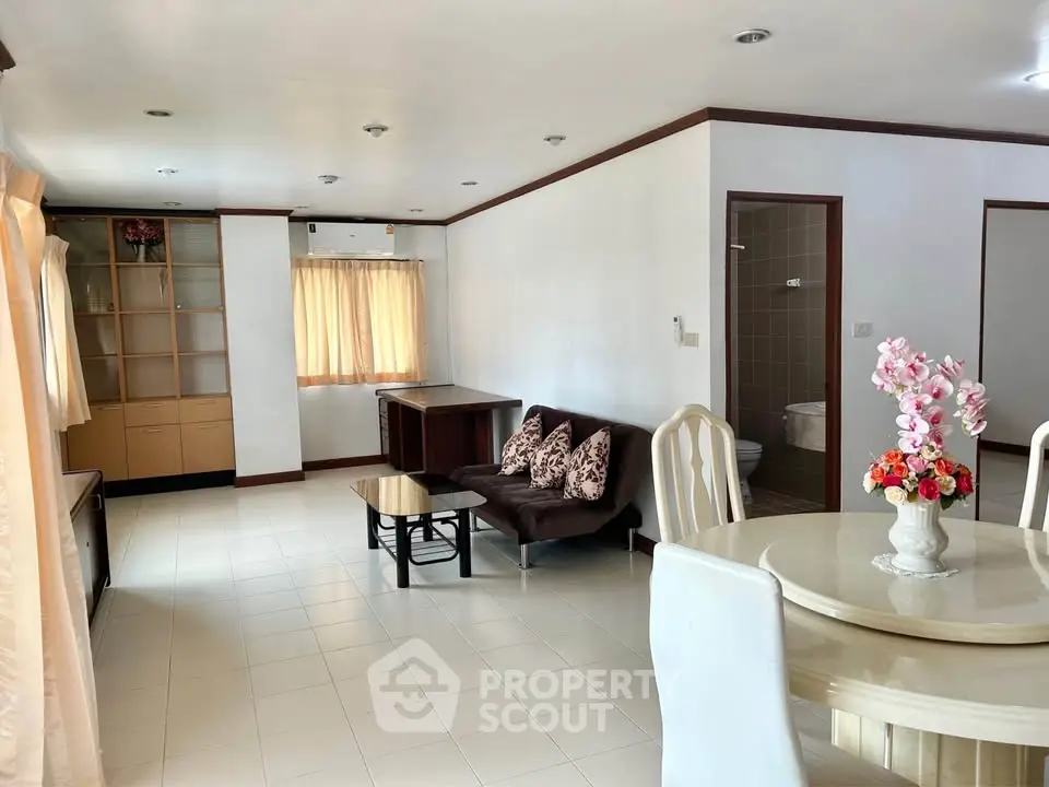 Spacious living room with elegant dining area and natural light