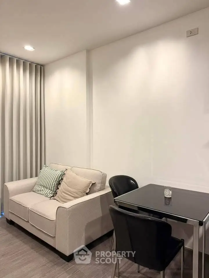 Modern living room with cozy sofa and dining table in a stylish apartment.