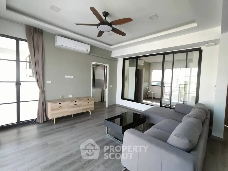 Spacious modern living room with large windows and stylish furniture